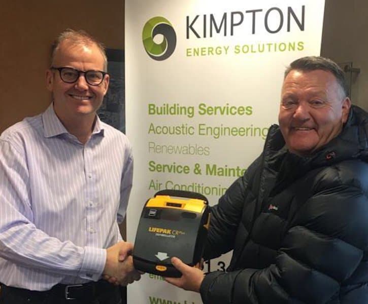 Richard Kimpton with Mark King of Oliver King Foundation handing over the defibrillator