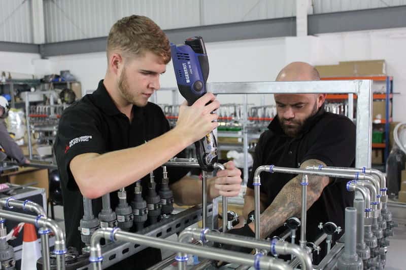 The team work together to assemble the test rig by Kimpton for the Washing Machine Barrier Plant