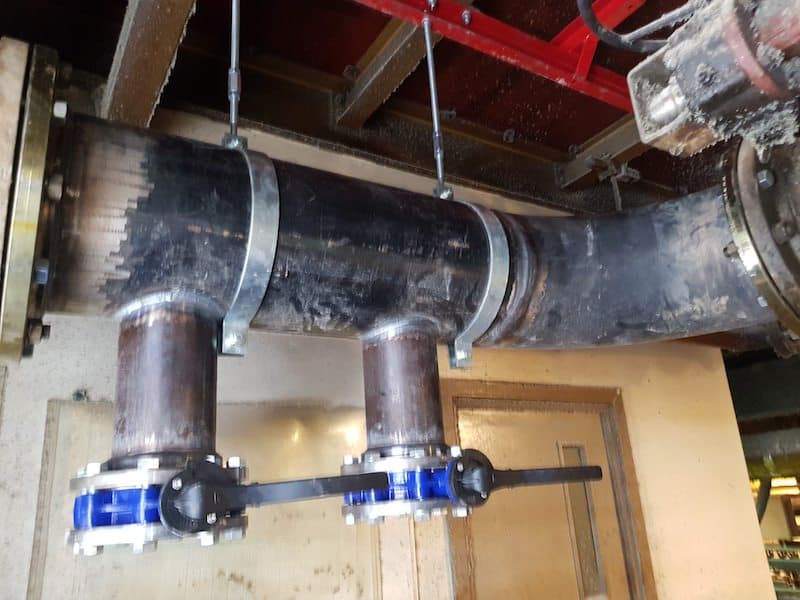 industrial pipework with the header pipe extension is secured and in place.