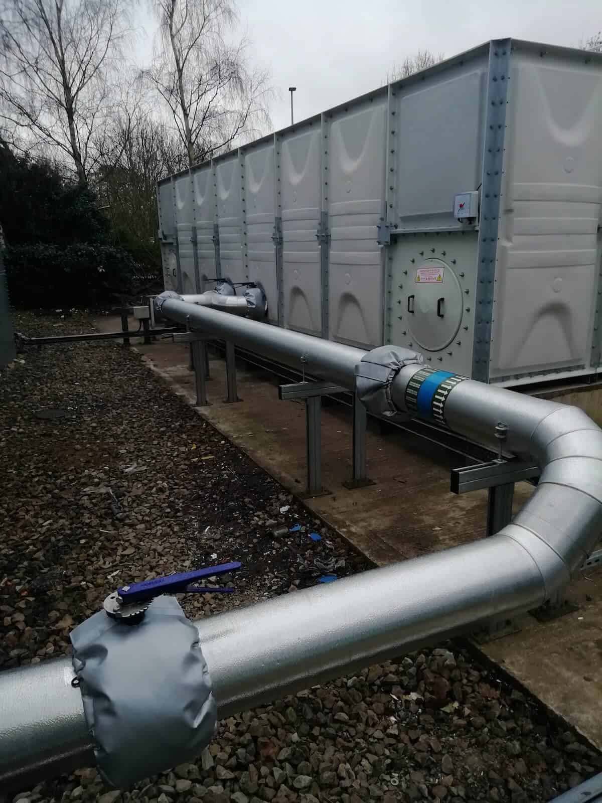 Wide view of outlet pipework with view of access panel bottom right of the new cold water tank