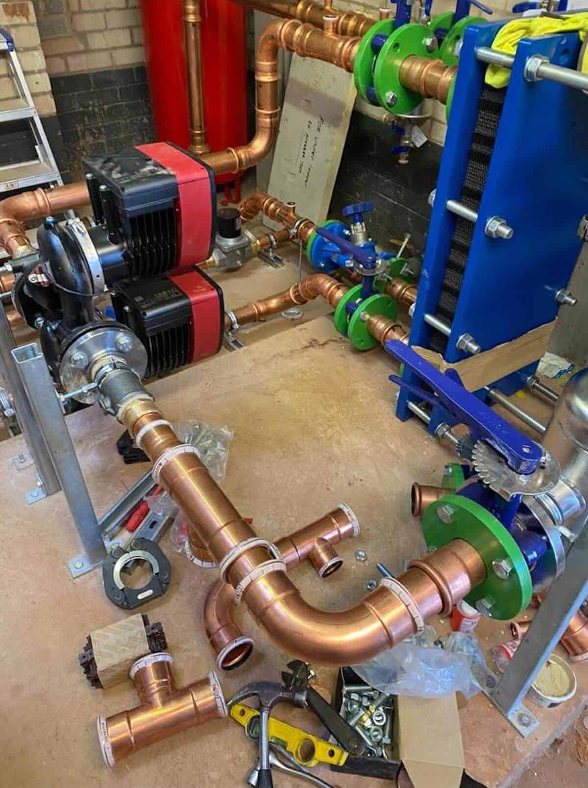 The system installed prior to lagging with the PHE pumps and pipework visible