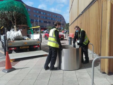 The large stainless containers are unloaded