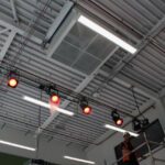 Inside the main hall at Plas Derwen PRU Queensferry the natural ventilation system uses a roof mounted fan with mechanical services by Kimpton