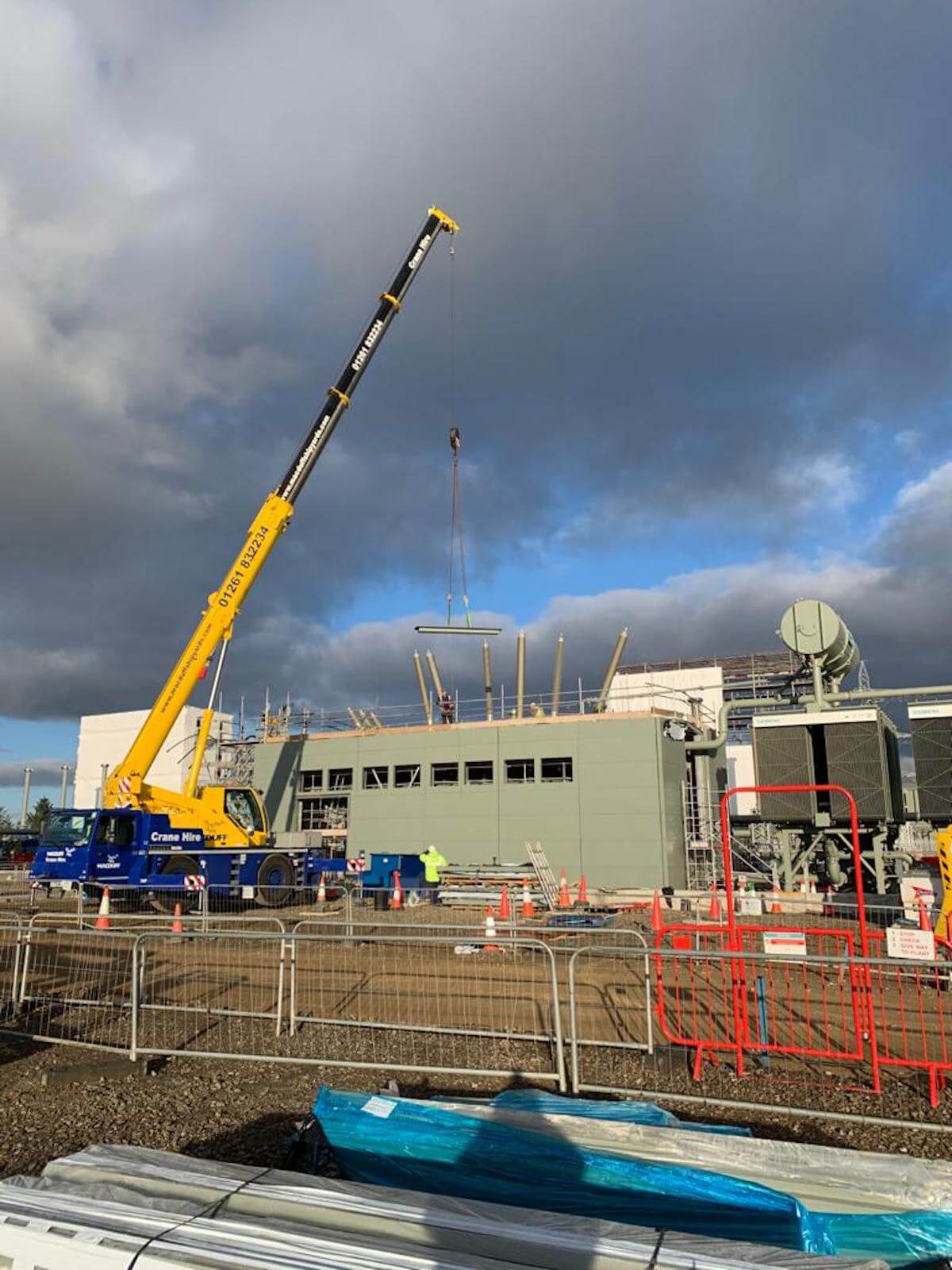 12 The crane lifts the roof panels into place