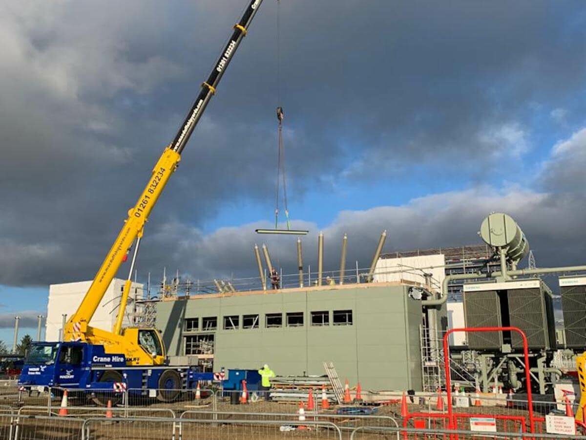4 Cranes on site lifting panels into place for fixing