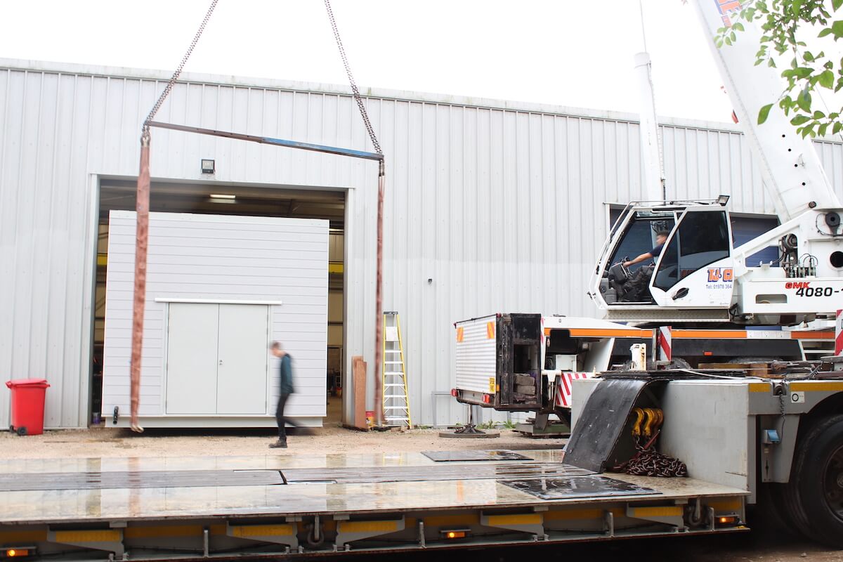 The acoustic plant room is pulled out and the lifting straps added