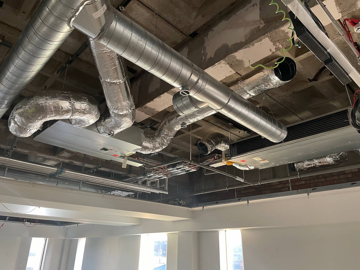 Near finished and insulated ducting within the roof void CAT A office refurbishment in Liverpool by Kimpton