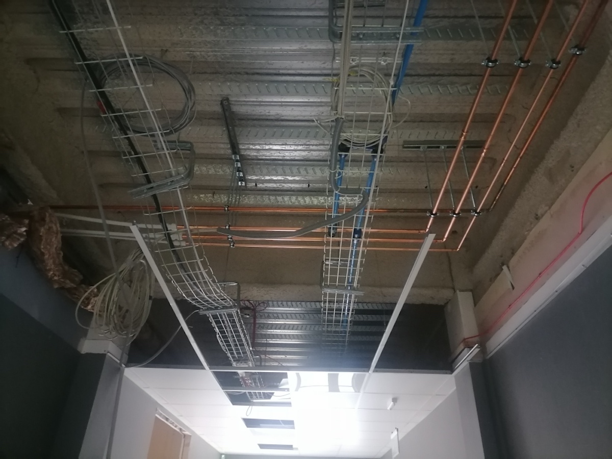 Pipework in the ceiling of the Biograd Liverpool Stem Cell Laboratory during refurbishment by Kimpton